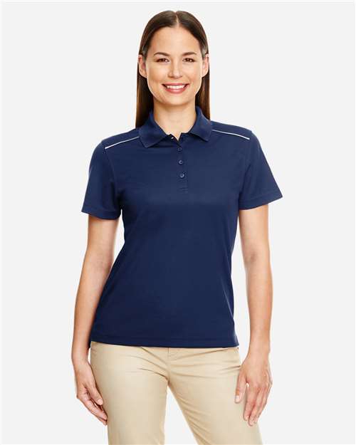 CORE365 Women's Radiant Performance Piqué Polo with Reflective Piping — Classic Navy — On model · front